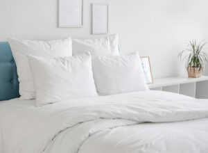 White pillows and duvet on the blue bed.